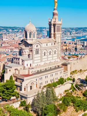 Admire the Notre-Dame de la Garde basilica perched above Marseille, offering breathtaking panoramic views of the city – Guided tour included with the Marseille Pass.